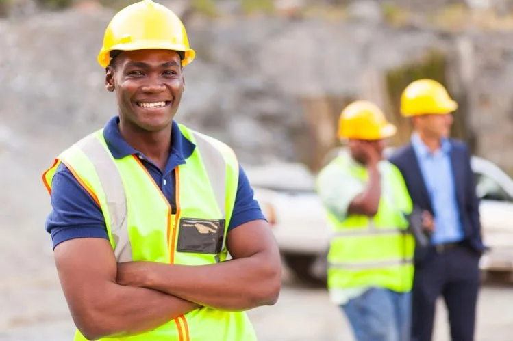 20022641 - happy african industrial worker with arms folded
