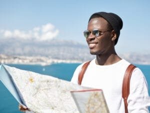 handsome-cheerful-young-male-tourist-dressed-stylish-clothing-smiling-happily